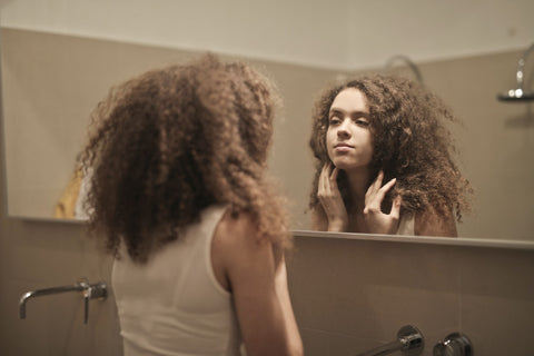 Woman looks self on mirror