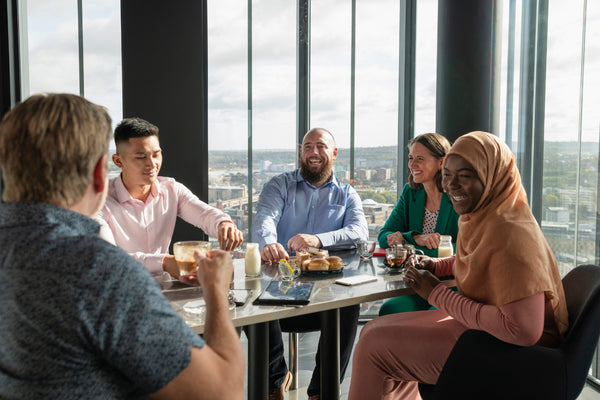 Colleagues eating lunch and laughing.