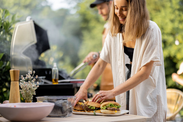 Woman making hamburgers for friends.