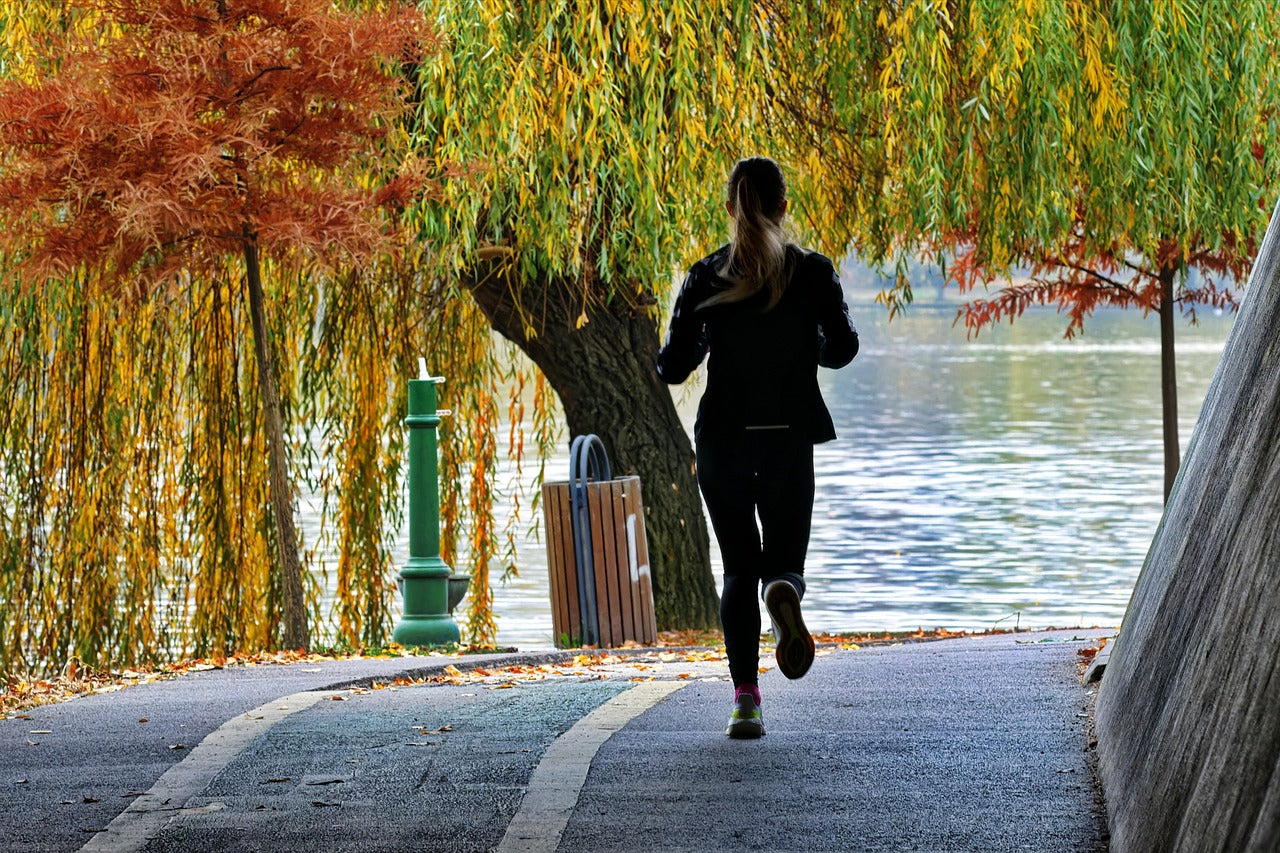 Person running down path in fall