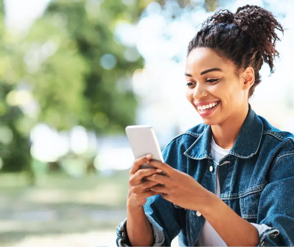 A person holding their phone, using an app for emotional regulation.