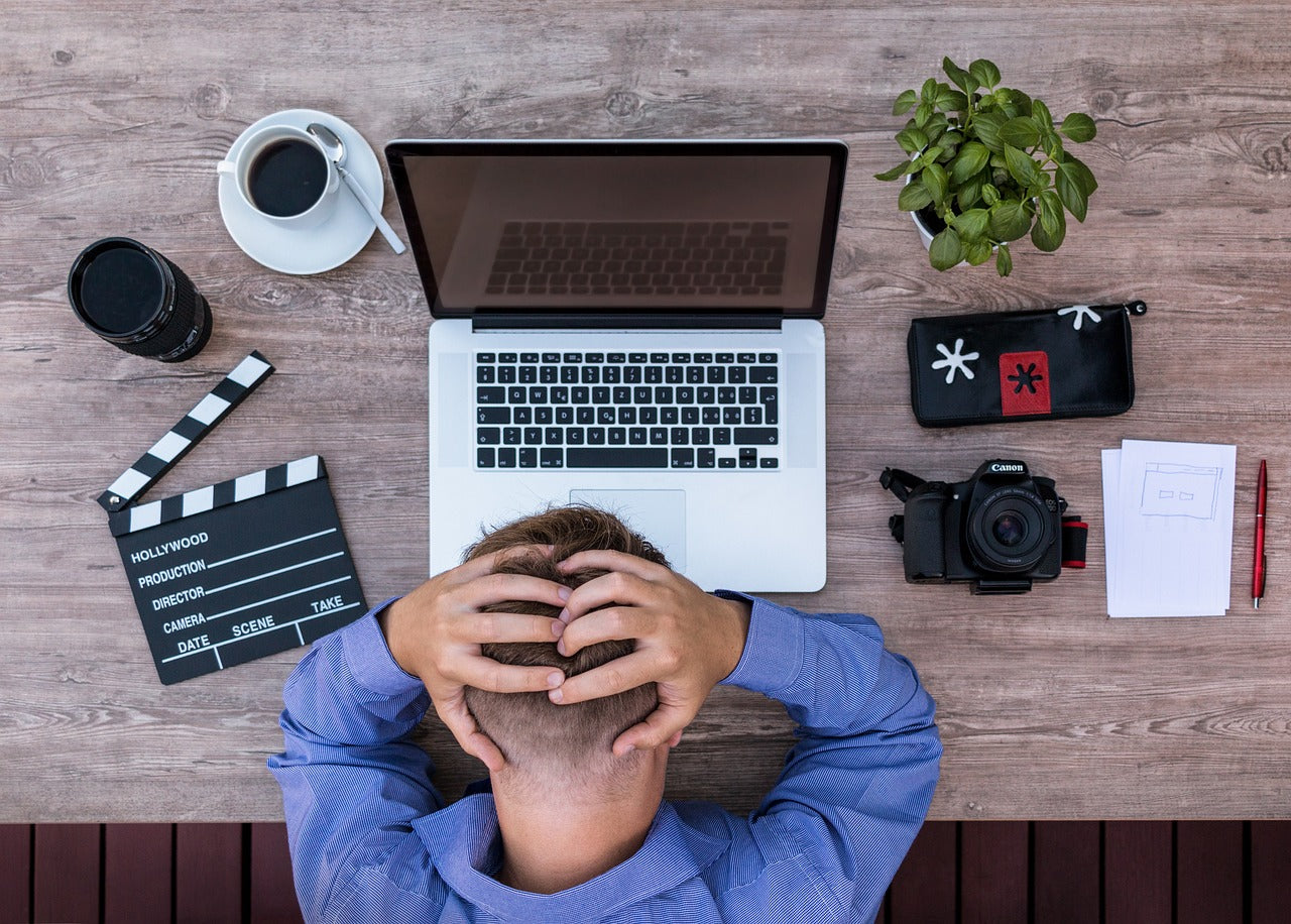 Person stressed in front of laptop