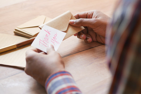 Giving thank you notes to friends.