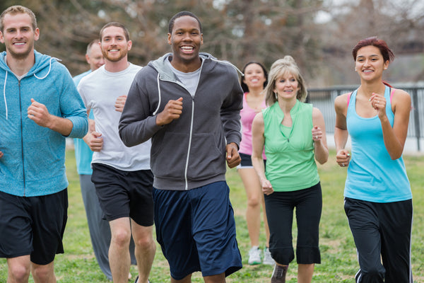 A group of people exercising together in a park.