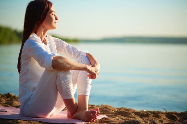 A person sitting in a peaceful outdoor setting.