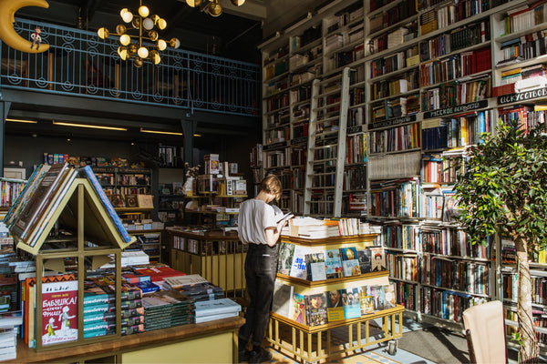 Reading a book in a cozy bookstore.