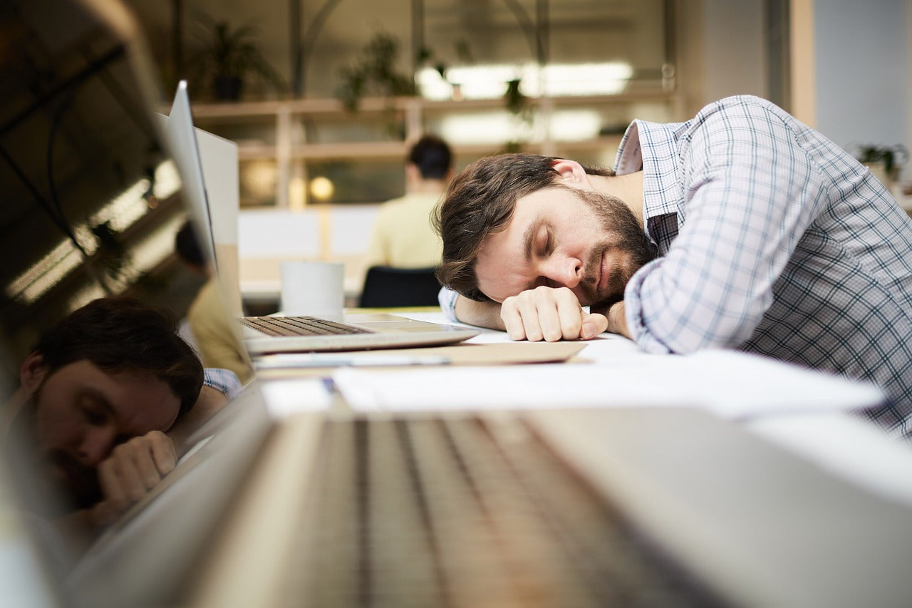 Person falling asleep at work desk