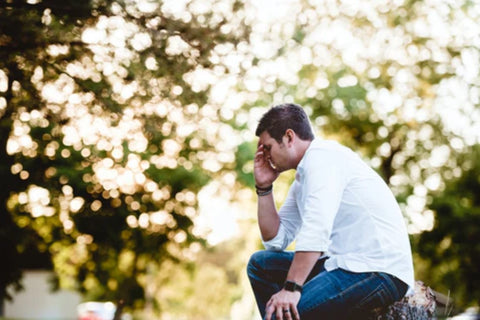 man looking stress with tress in the background