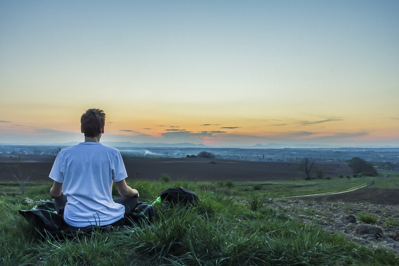 Person meditating outside