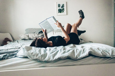 Woman enjoys reading in bed