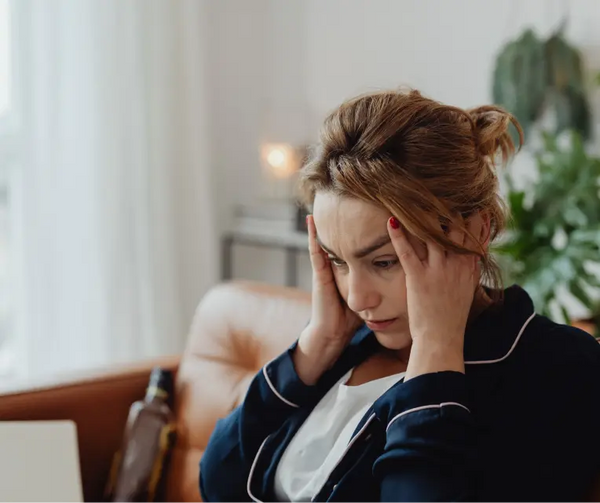 A person holding their head in distress.