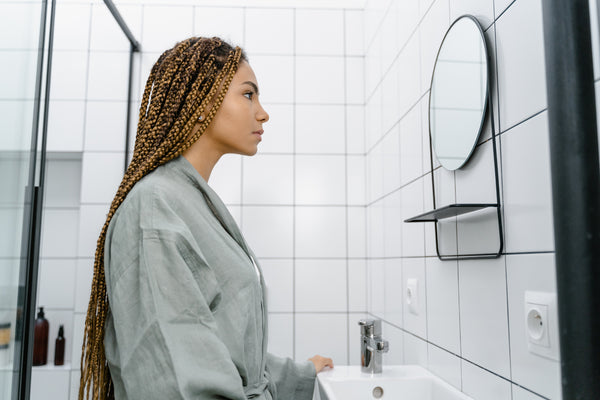 Woman looking at herself in the mirror.