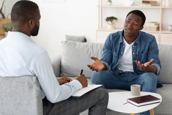 Therapist talking to a patient in a cozy office.