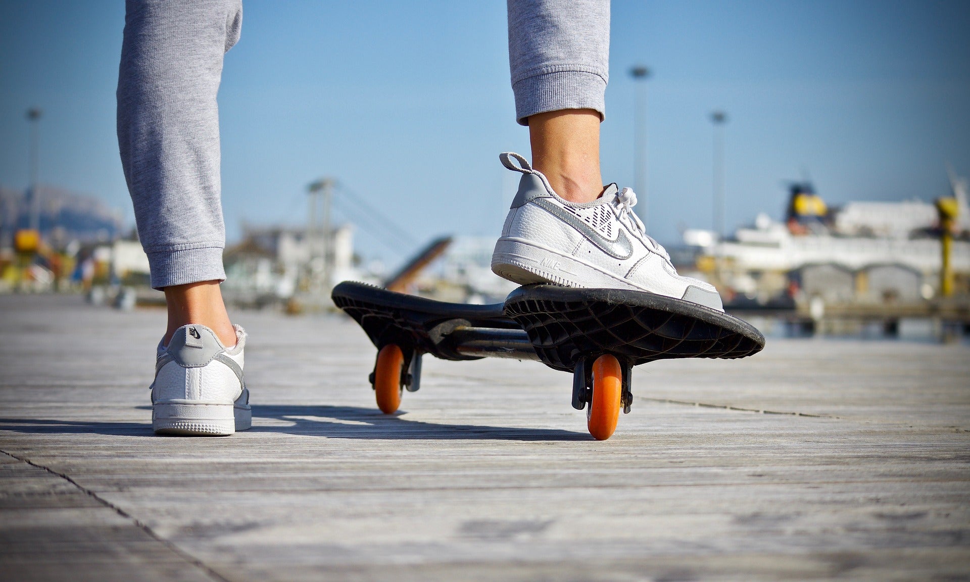 Person about to ride skateboard with just their feet shown