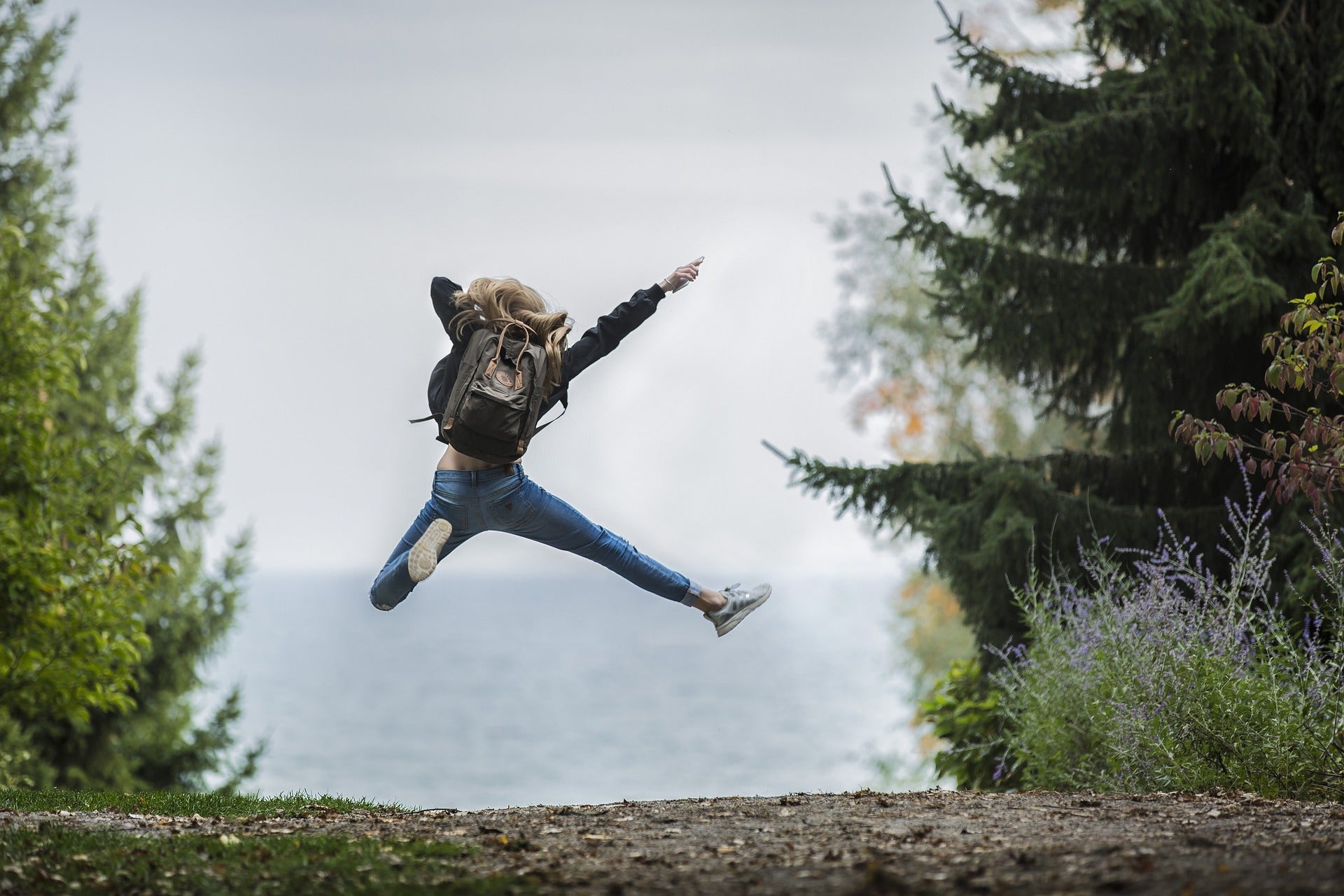 Person jumping in the air in front of ocean view