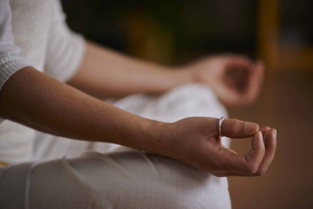 Person meditating while seated