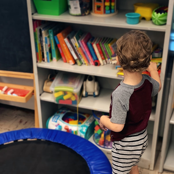 Young boy picking from a list of books