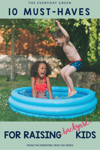 Two kids jumping in a backyard pool