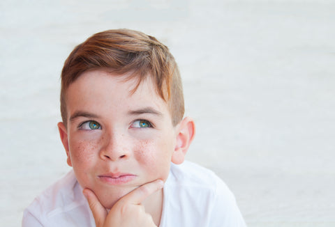 Child pondering the best words to make his mother go prematurely gray.