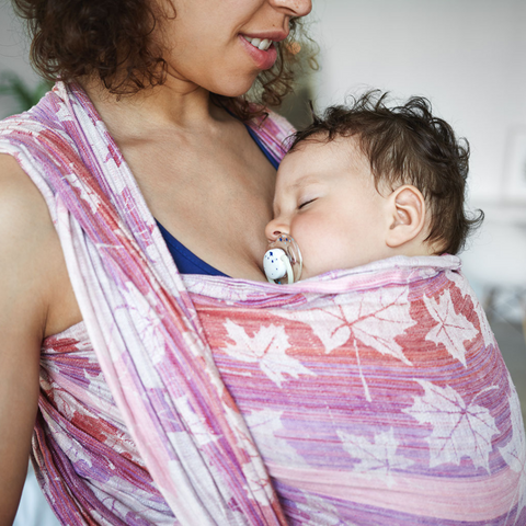 Mother wearing baby in a woven wrap