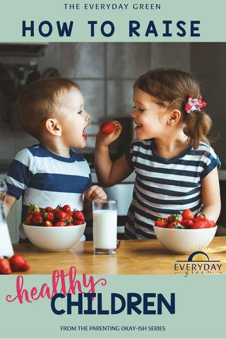 how to raise healthy children blog article, sister feeding baby brother strawberries