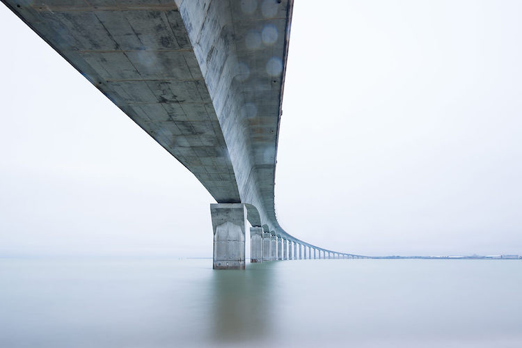 Water below the bridge captured as a silky smooth texture at day time with long shutter speeds and by the help of a Neutral Density filter