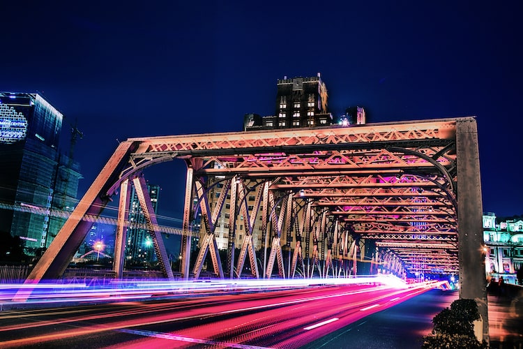 cars passing on the bridge by night