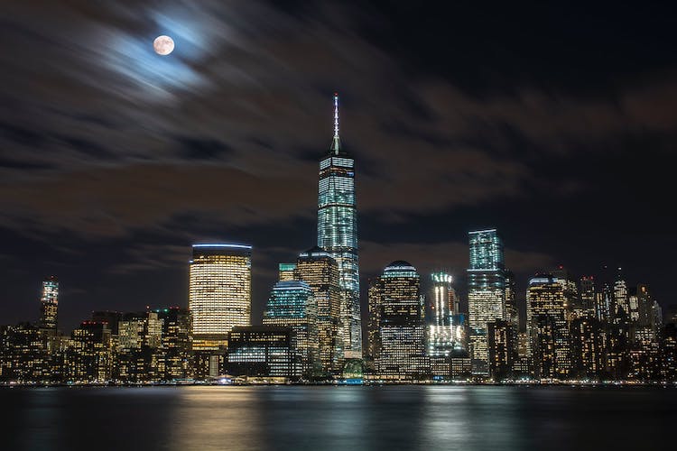 clouds moving above new york skyline at night