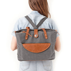 The back of a woman showing the Grey CarryAll being worn as a backpack.