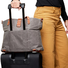 Grey CarryAll Travel Bag showing a suitcase handle going through the luggage sleeve.