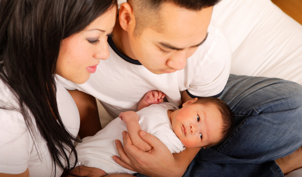 New parents holding their baby