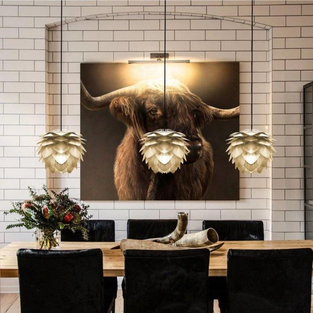 A dining room with gold decorative lighting fixtures.