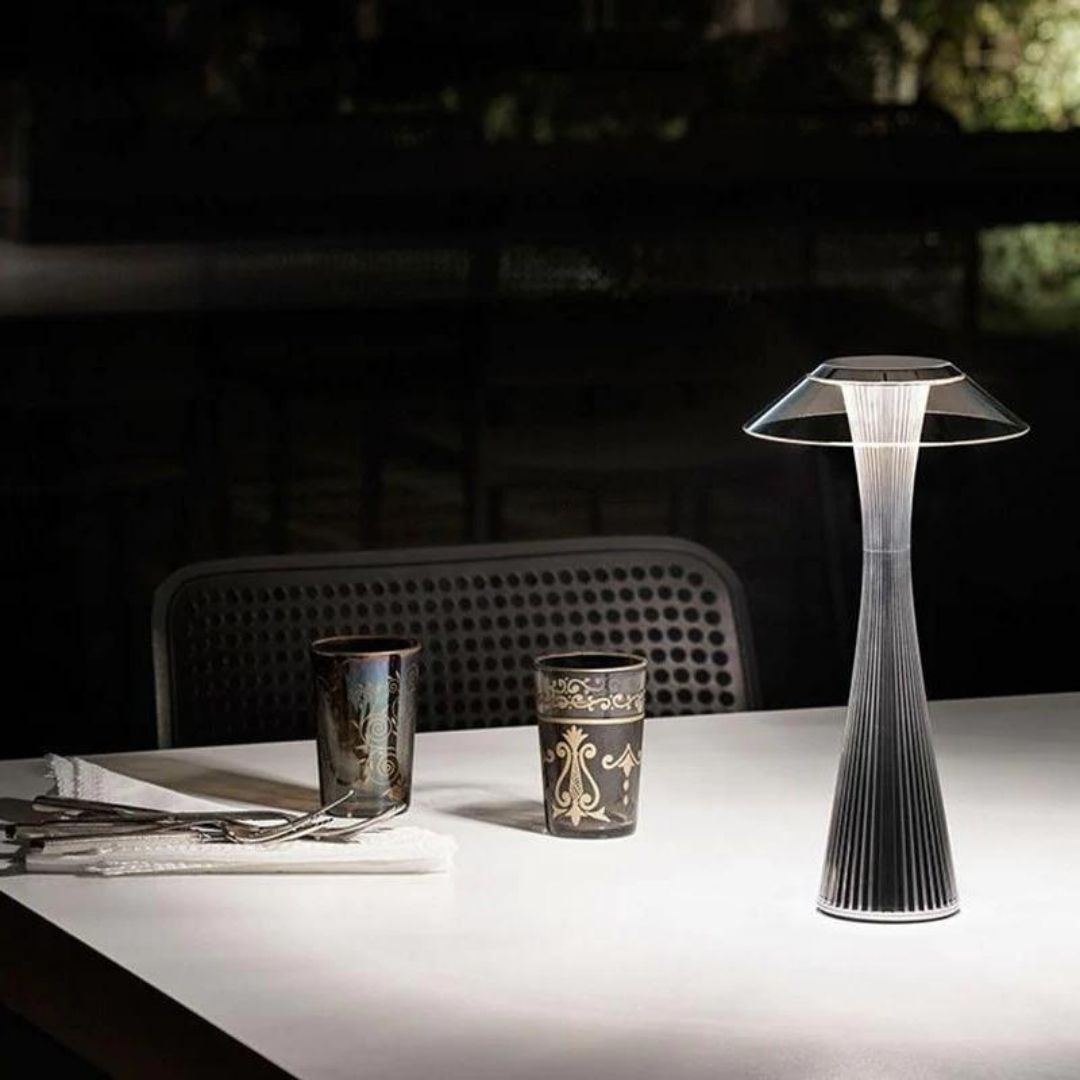 A dining table with a small decorative lamp.