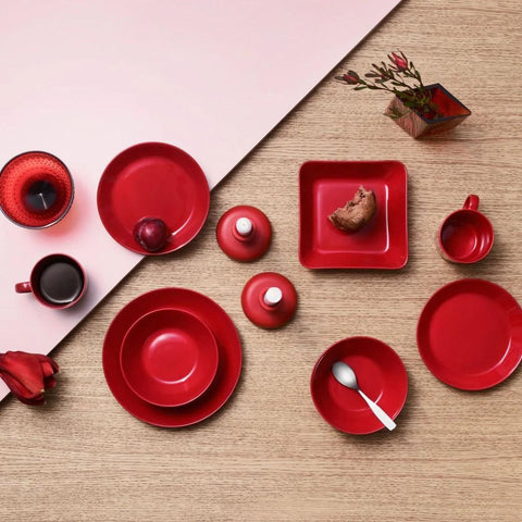 Image from above of red dishes on a table