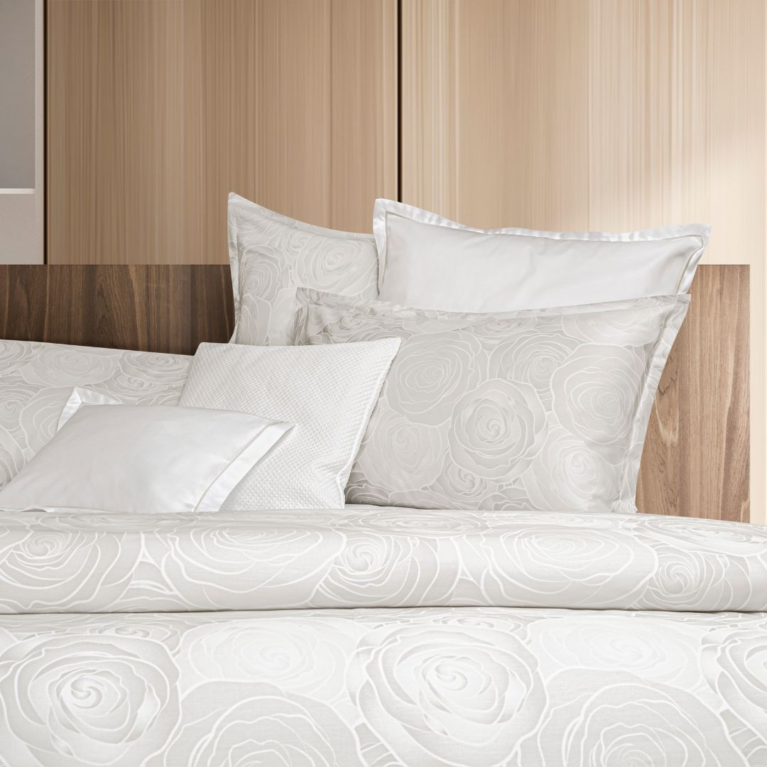 an assortment of pillow sizes on a bed