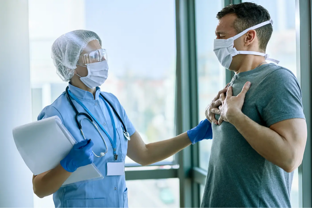 doctor and patient wearing a mask with the patient standing at the lungs
