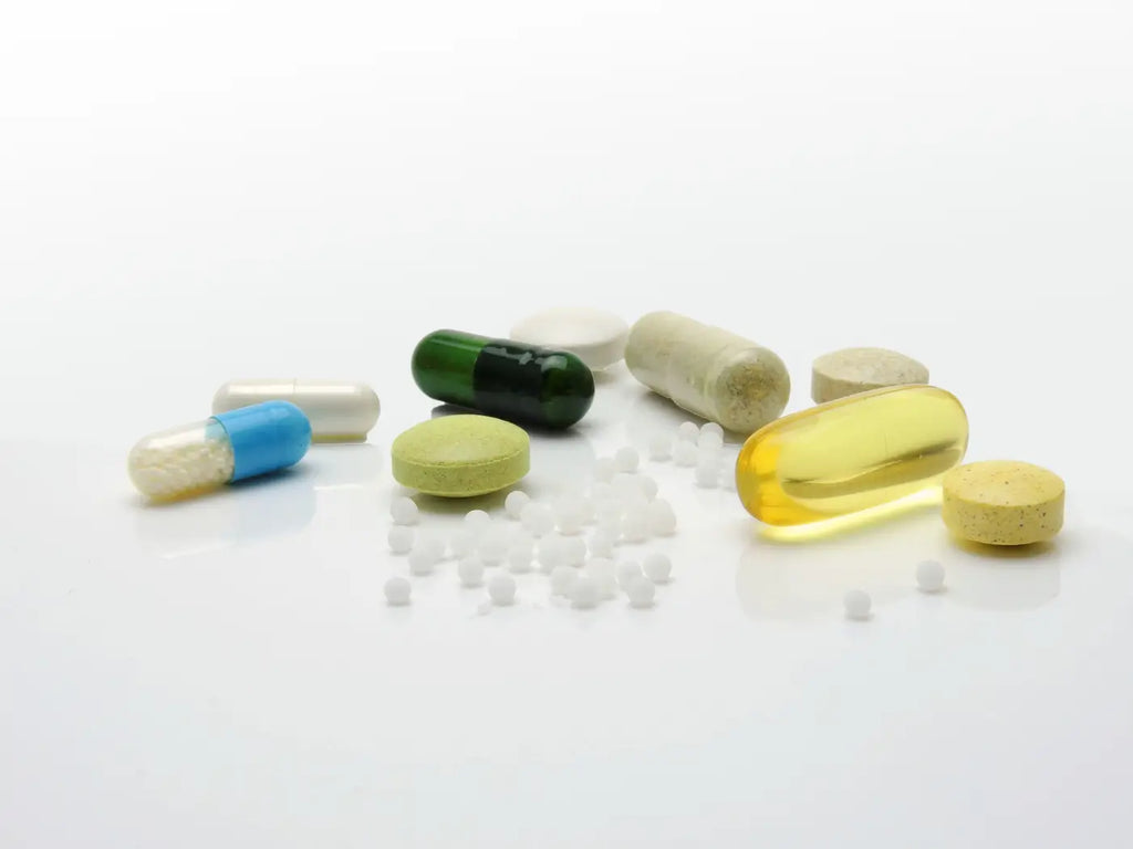 medicines and capsules of all kinds lying on a white table
