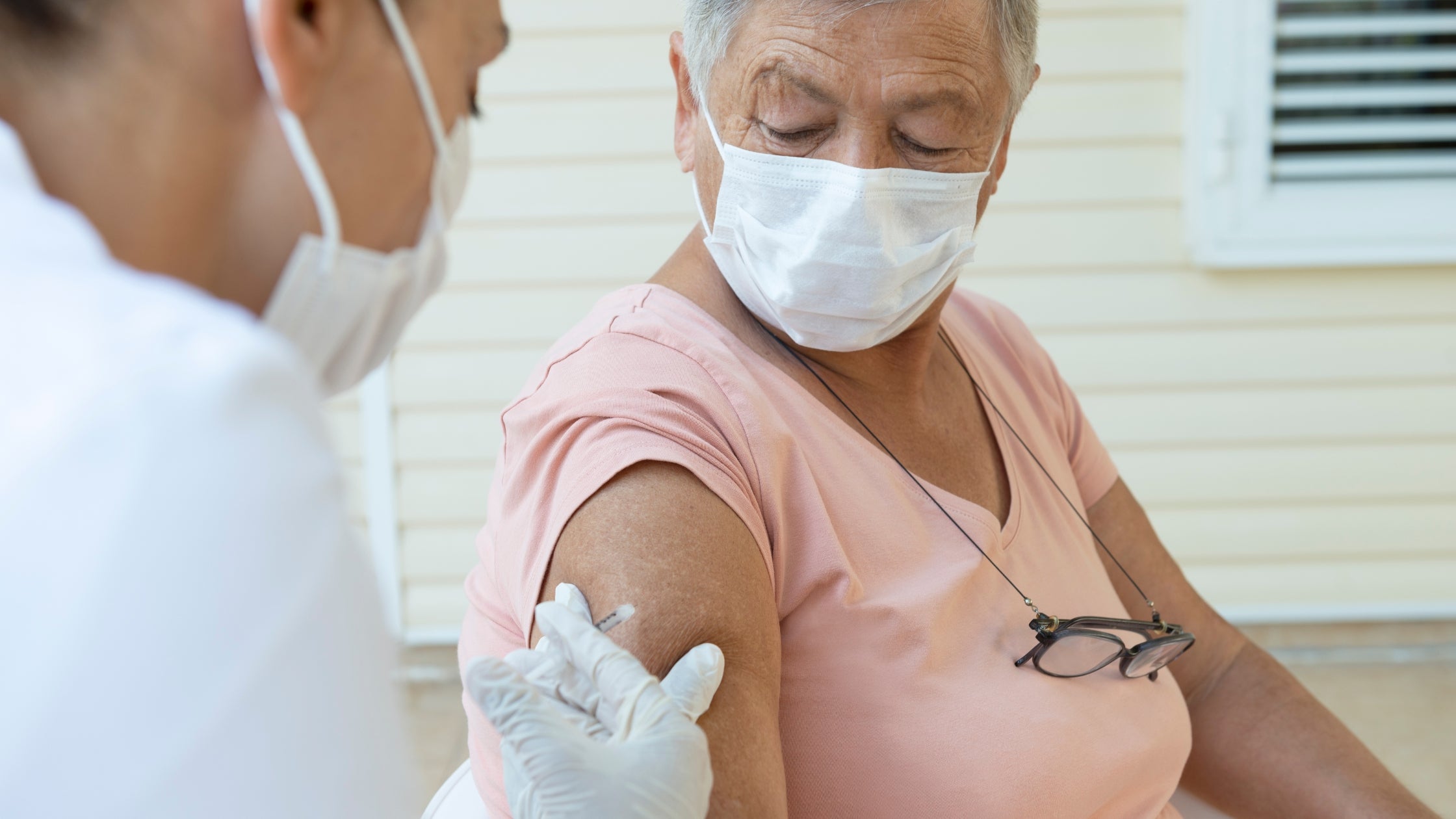 nurse giving vaccine to old woman with copd