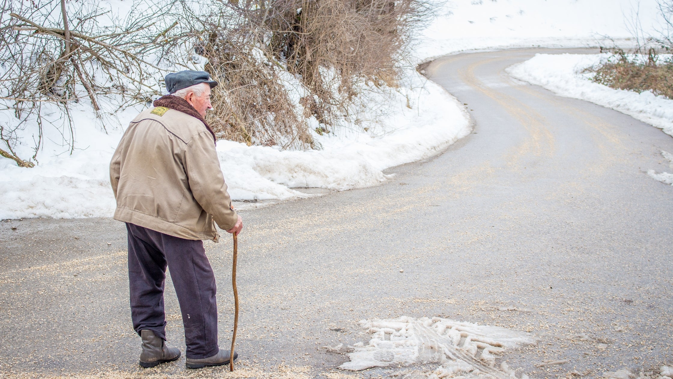 old man walking outside in winter