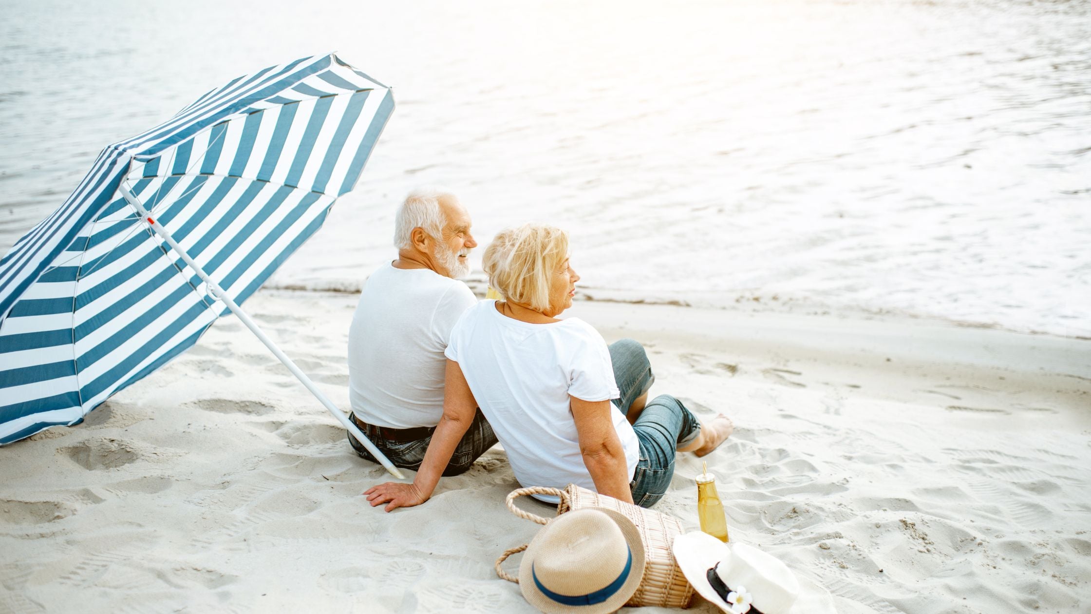 two elderly with COPD sitting at the beach