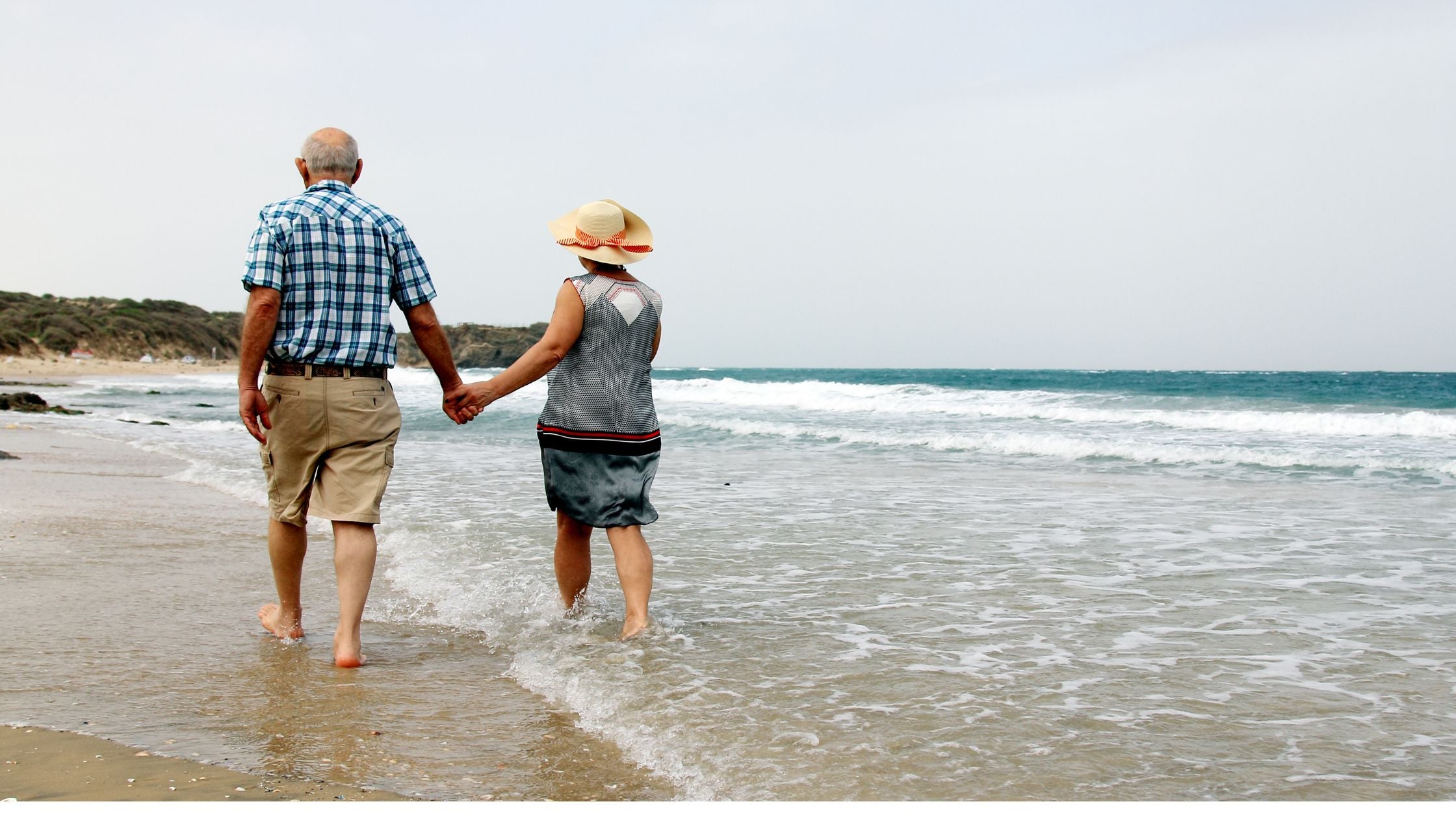 two elderly with COPD walking by the beach