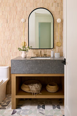 bathroom with pretty salmon colored, textured tile wall