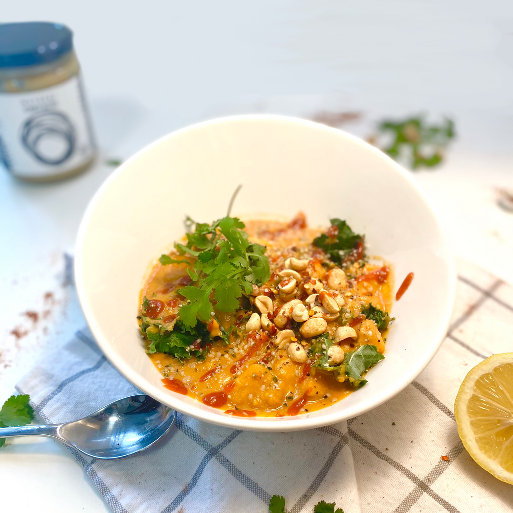 Natural peanut butter, sweet potato stew topped with roasted peanuts, sriracha, cilantro, and hemp hearts.