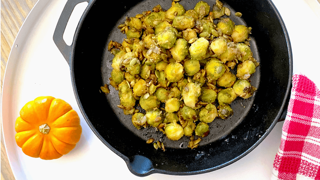 Roasted brussel sprouts recipe with maple peanut butter sauce and roasted pumpkin seeds
