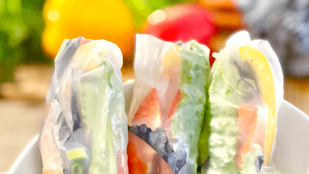 Tops-of-summer-rice-wrap-rolls -with-colourful-veggies-in-background