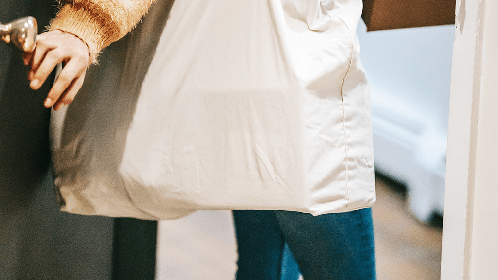 Woman-Leaving-Door-Carrying-Tote-Bag