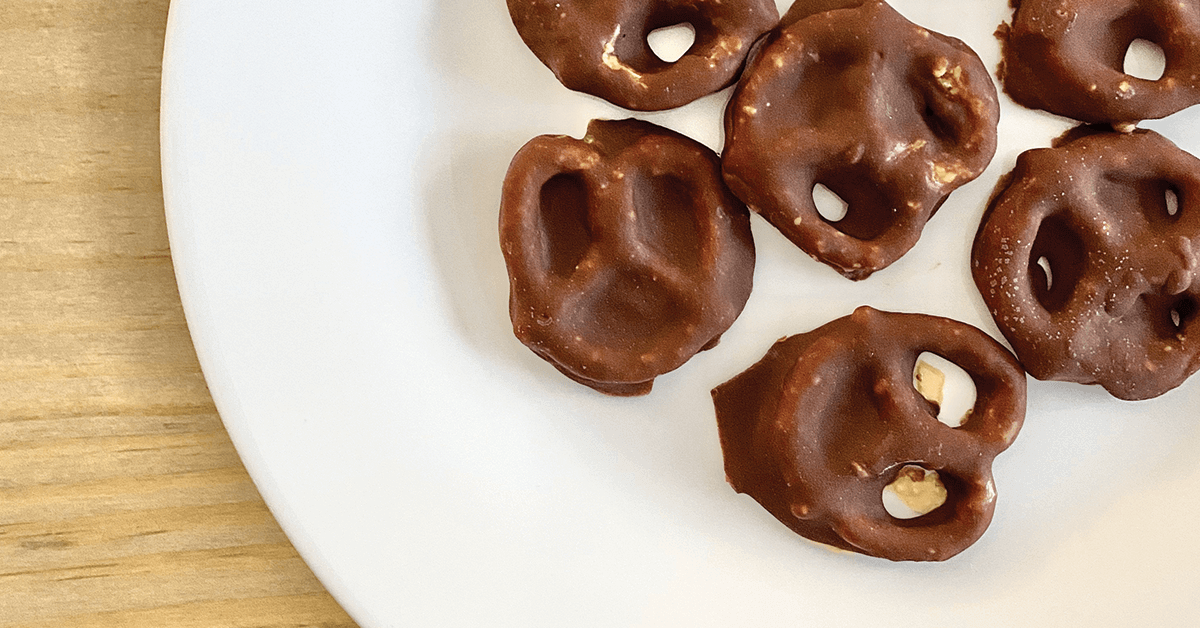 Chocolate covered PB pretzels on white plate