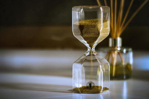 an hour-glass on a table