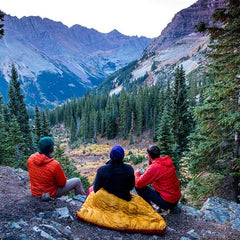 three friends are camping on mountains