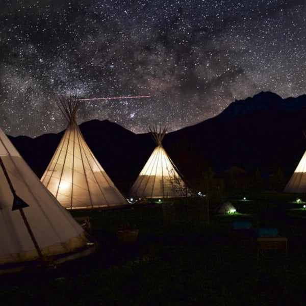 a pleasent bright sky full of stars and beautiful view of the tepee village in montana usa